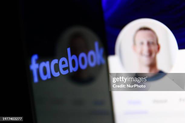 Facebook logo displayed on a phone screen and Mark Zuckerberg account on Facebook website displayed on a laptop screen are seen in this illustration...