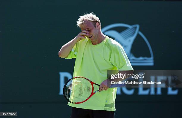 Stefan Koubek of Austria wipes his eyes while playing Marat Safin of Russia during the Pacific Life Open at the Indian Wells Tennis Garden on March...