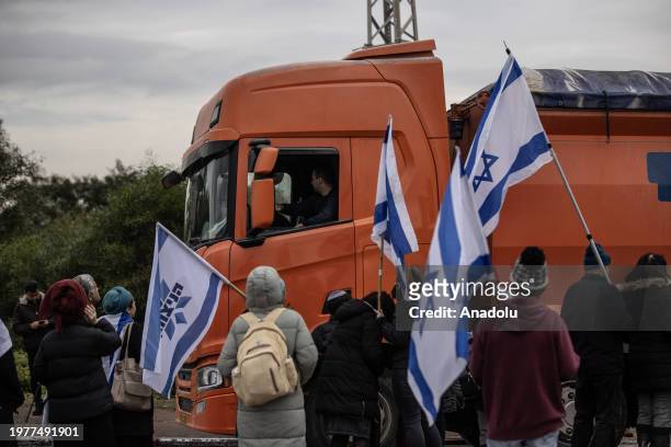 Activist Jewish settler group of dozens of people, holding Israeli flags, gather at the exit of Ashdod Port near the Gaza Strip and block trucks...