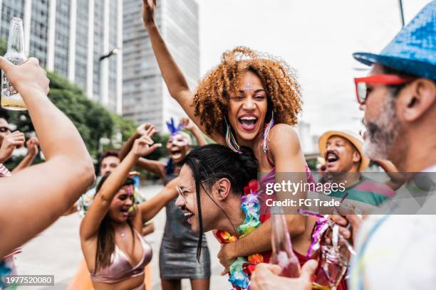 friends having fun at a street carnival party - straatfeest stockfoto's en -beelden