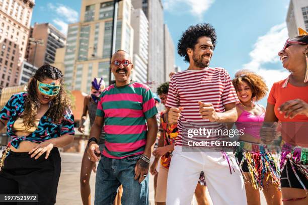 group of people having fun at a street carnival party - street party stock pictures, royalty-free photos & images