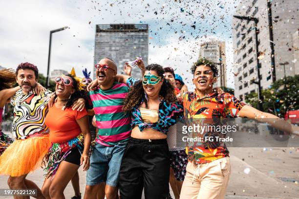 group of people having fun at a street carnival party - reünie sociaal stockfoto's en -beelden