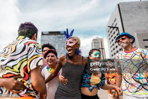 group of people having fun at a street carnival party - reünie sociaal stockfoto's en -beelden