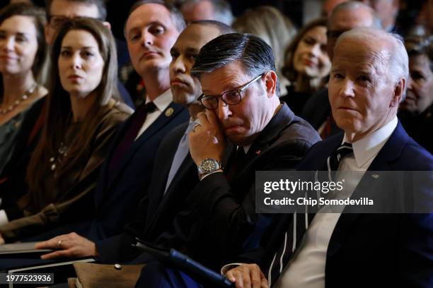 Speaker of the House Mike Johnson wipes away a tear as he, U.S. President Joe Biden and House Minority Leader Hakeem Jeffries listen to Andrea...