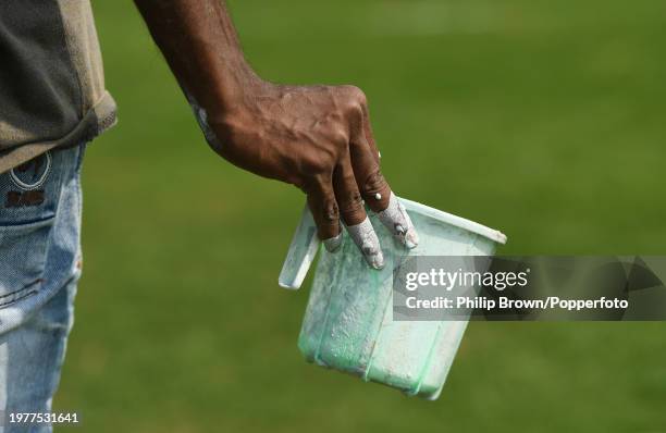 Member of the ground staff ready to mark a line around a cricket ground in the nets area during the England Net Session at ACA-VDCA Stadium on...