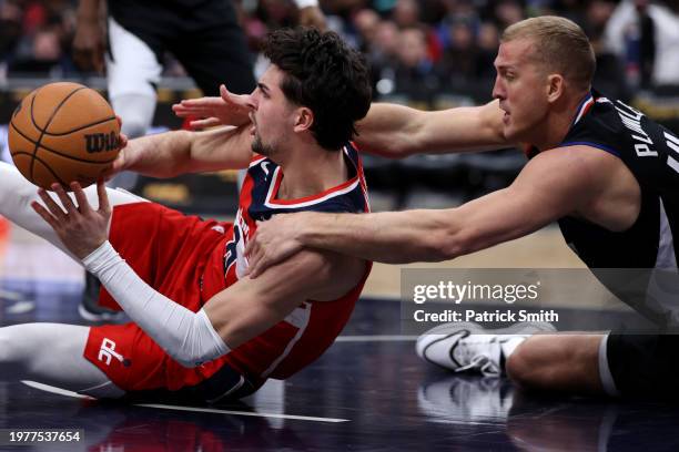 Deni Avdija of the Washington Wizards grabs a rebound in front of Mason Plumlee of the LA Clippers during second half at Capital One Arena on January...