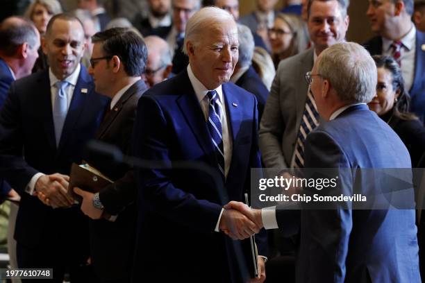 President Joe Biden greets fellow guests at the conclusion of the annual National Prayer Breakfast in Statuary Hall in the U.S. Capitol on February...