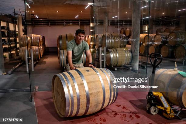 Winemaker Matthew Day rolls a barrel from the cellar through the winery at the historic Klein Constantia Wine Estate on February 1, 2024 near Cape...