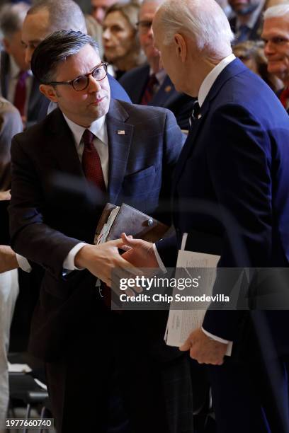 Speaker of the House Mike Johnson shakes hands with U.S. President Joe Biden at the conclusion of the annual National Prayer Breakfast in Statuary...