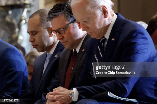 President Joe Biden, Speaker of the House Mike Johnson and House Minority Leader Hakeem Jeffries bow their heads during the annual National Prayer...