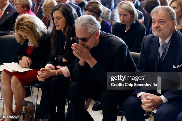 Italian tenor Andrea Bocelli and his wife Veronica Berti pray during the annual National Prayer Breakfast in the Statuary Hall of the U.S. Capitol on...