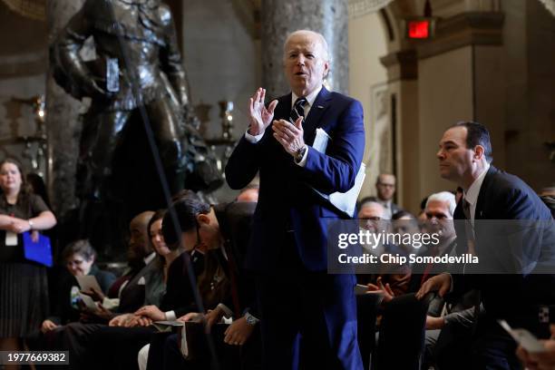 President Joe Biden leaps up to give a standing ovation to Andrea Bocelli during the annual National Prayer Breakfast in Statuary Hall in the U.S....