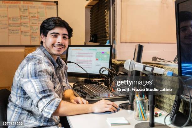 portrait of a young man working mixing at radio show - geluidsoverlast stockfoto's en -beelden