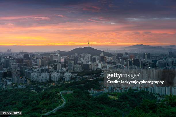 sunrise over the seoul skyline in the downtown area an early morning twilight view of namsan park's n seoul tower from above. seoul, south korea - seoul south korea skyline stock pictures, royalty-free photos & images