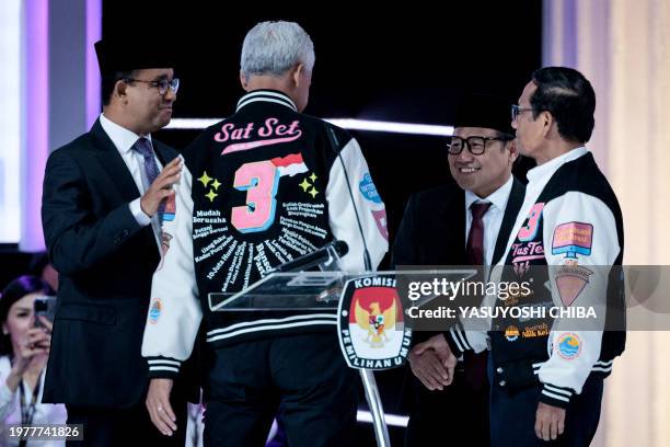 Presidential candidate and former Central Java governor Ganjar Pranowo and vice presidential candidate Mahfud MD greet with presidential candidate...