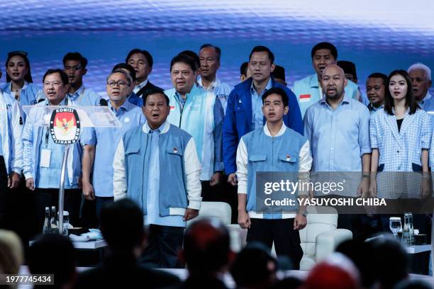 Presidential candidate and Indonesia's Defence Minister Prabowo Subianto and vice presidential candidate Gibran Rakabuming Raka sing the national...