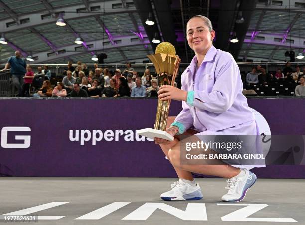 Latvia's Jelena Ostapenko poses with her trophy after winning against Russia's Ekaterina Alexandrova during the final match of the WTA Upper Austria...