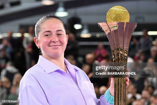 Latvia's Jelena Ostapenko poses with her trophy after winning against Russia's Ekaterina Alexandrova during the final match of the WTA Upper Austria...