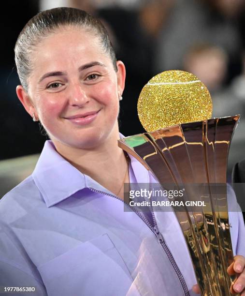 Latvia's Jelena Ostapenko poses with her trophy after winning against Russia's Ekaterina Alexandrova during the final match of the WTA Upper Austria...