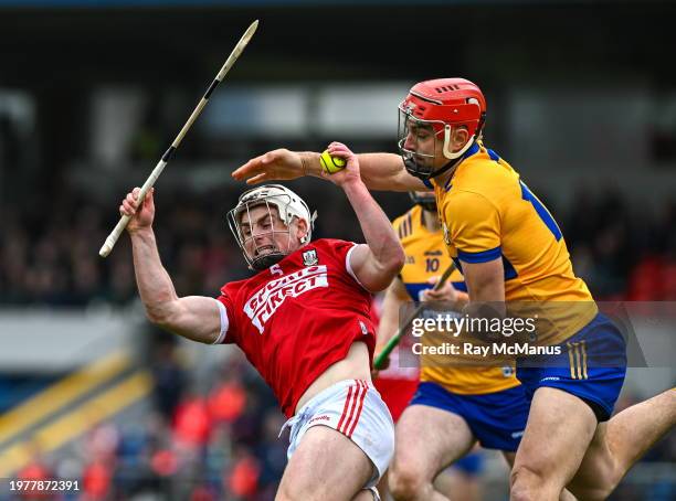 Clare , Ireland - 4 February 2024; Tommy O'Connell of Cork is tackled by Peter Duggan of Clare during the Allianz Hurling League Division 1 Group A...