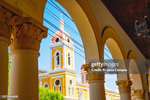 the cathedral of granada - nicaragua seen through arches of building - colonialism stock pictures, royalty-free photos & images