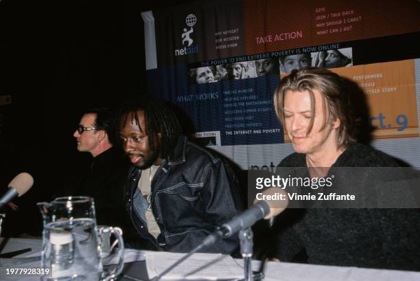 Irish singer Bono, Haitian rapper and musician Wyclef Jean, and British singer-songwriter and musician David Bowie attend press conference for Net...