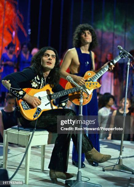 From left, Mickey Finn and Marc Bolan of British pop group T. Rex perform on the set of a pop music television show in London circa 1971.