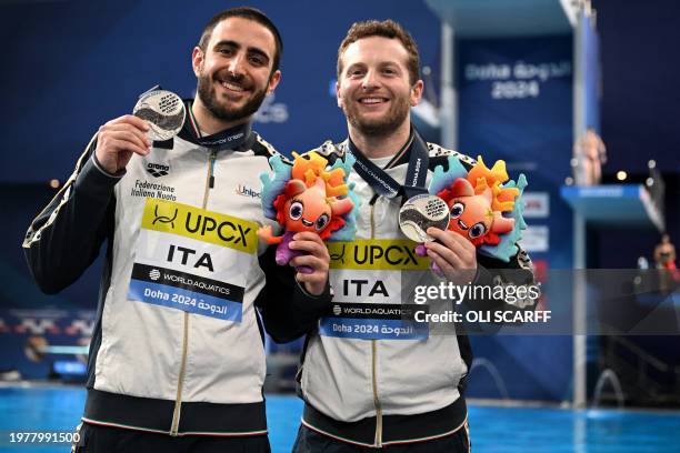 Silver medallists Italy's Giovanni Tocci and Lorenzo Marsaglia pose during the medal ceremony of the final of the men's 3m springboard synchro diving...