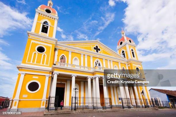 senior lady entering the cathedral of granada - nicaragua - nicaragua stock pictures, royalty-free photos & images