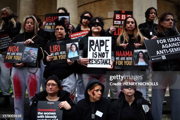 Protesters wearing fake blood make-up and holding placards take part in a demonstration "Rape is NOT resistance" outside the BBC headquarters, in...