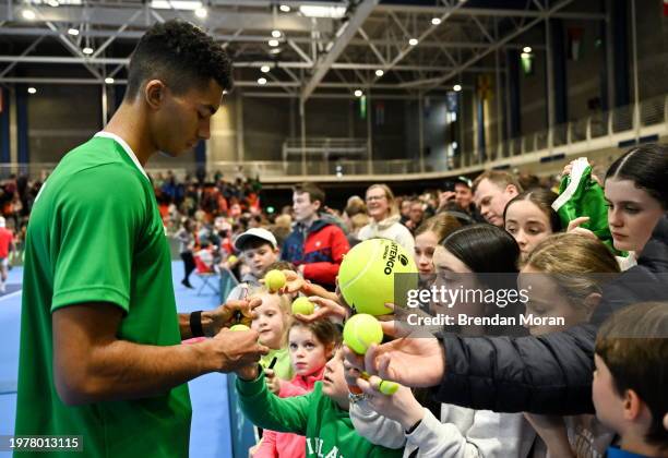 Limerick , Ireland - 4 February 2024; Michael Agwi of Ireland signs autographs for supporters after his singles match against Lucas Miedler of...