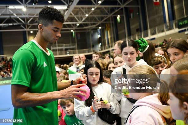 Limerick , Ireland - 4 February 2024; Michael Agwi of Ireland signs autographs for supporters after his singles match against Lucas Miedler of...