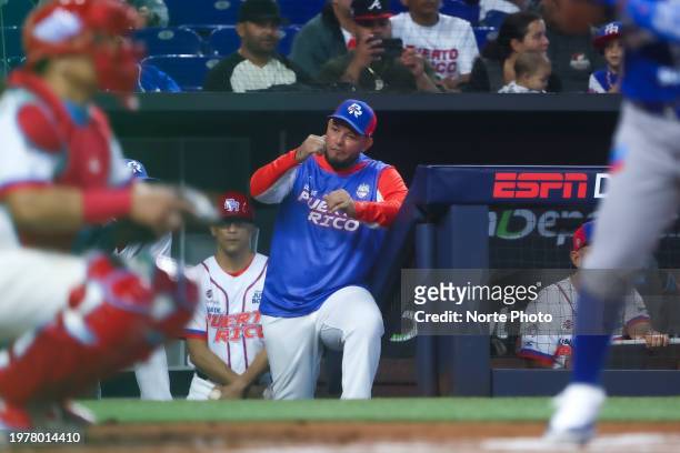 Manager Yadier Molina of Criollos de Caguas of Puerto Rico signals from the dugout during a game between Nicaragua and Puerto Rico at loanDepot park...