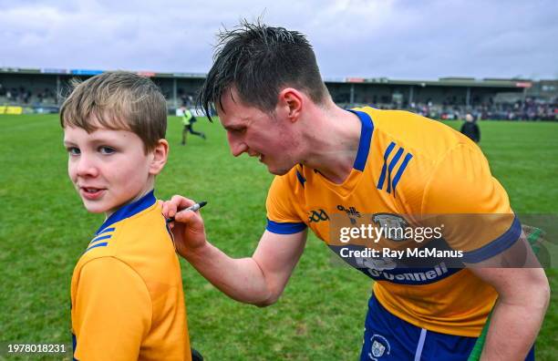 Clare , Ireland - 4 February 2024; Diarmuid Ryan of Clare autographs the shirt of Clare supporter Morgan Meehan, 10 years, from Feakle, after the...