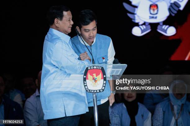 Presidential candidate and Indonesia's Defence Minister Prabowo Subianto reacts with vice presidential candidate Gibran Rakabuming Raka during the...