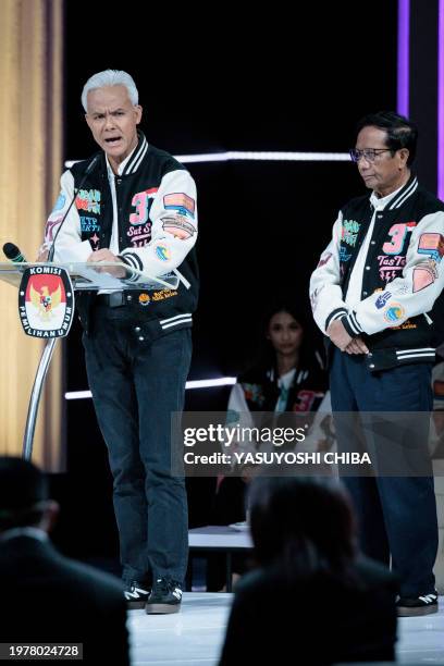 Presidential candidate and former Central Java governor Ganjar Pranowo speaks with vice presidential candidate Mahfud MD during the last presidential...