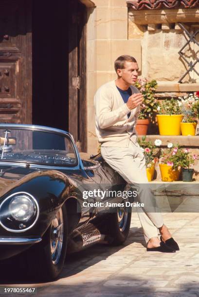 Actor and driving enthusiast Steve McQueen poses with his Jaguar XK-SS convertible at his Brentwood home in June, 1966 in Los Angeles, California.