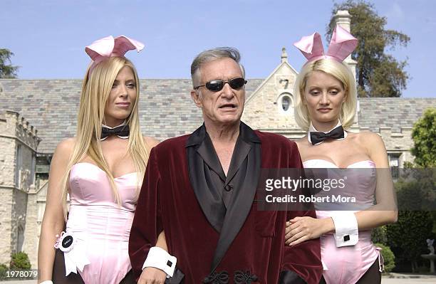 Playboy bunny Sheila Levell, Playboy founder Hugh Hefner and Playboy bunny Holly Madison perform a scene during the filming of a commercial for "X...