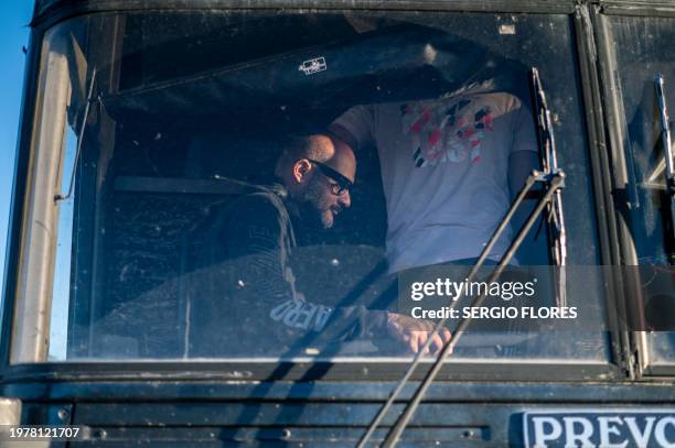 Migrants are loaded onto a bus after being processed and apprehended near the highway on February 4, 2024 outside Eagle Pass, Texas. Eagle Pass,...