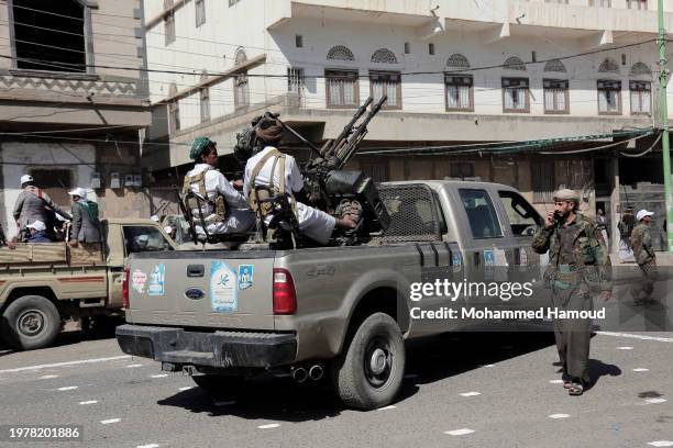 Yemen's Houthi fighters man a machine gun mounted on a vehicle while participating in a parade in solidarity with Palestinians and denounce the...