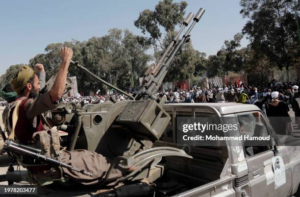 Yemen's Houthi fighters man a machine gun mounted on a vehicle while participating in a parade in solidarity with Palestinians and denounce the...