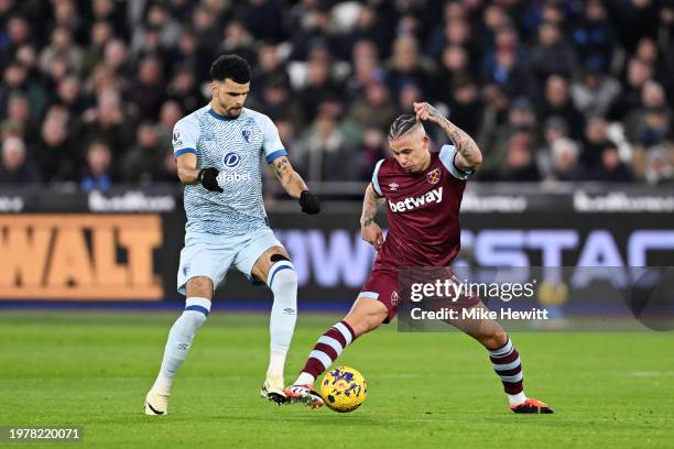 Kalvin Phillips of West Ham United is challenged by Dominic Solanke of AFC Bournemouth during the Premier League match between West Ham United and...
