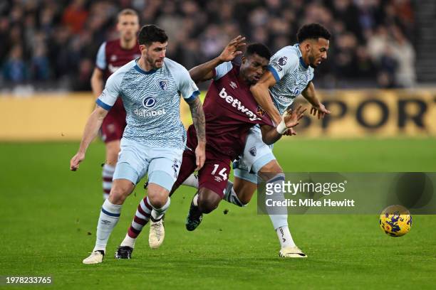 Mohammed Kudus of West Ham United is challenged by Marcos Senesi and Lloyd Kelly of AFC Bournemouth during the Premier League match between West Ham...