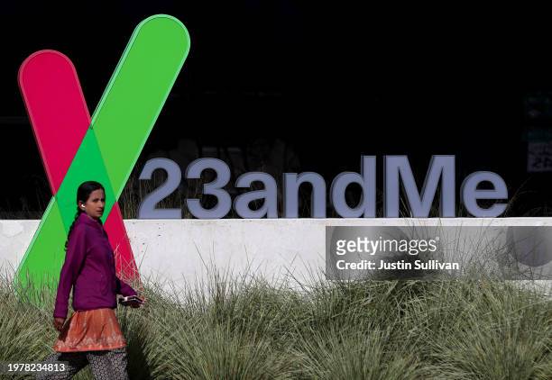 Pedestrian walks by a sign posted in front of the 23andMe headquarters on February 01, 2024 in Sunnyvale, California. Genetic testing company...
