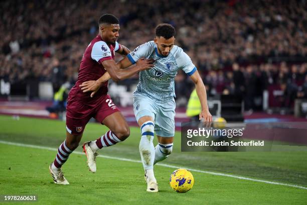 Marcus Tavernier of AFC Bournemouth is challenged by Ben Johnson of West Ham United during the Premier League match between West Ham United and AFC...
