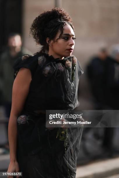 Celeste is seen wearing a black transparent dress with roses outside Jean Paul Gaultier Show during the Haute Couture Spring/Summer 2024 as part of...