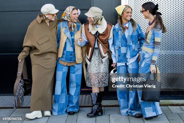 Amalie Nielsen wears grey baker boy hat, brown jacket, skirt & Rita Montezuma wears head scarf, beige quilted jacket, denim jacket, wide leg pants,...
