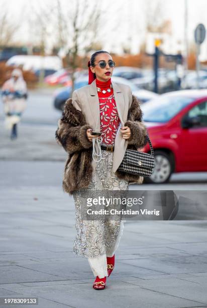 Gabriella Berdugo wears grey blazer, transparent skirt, houndstooth bag, red turtleneck, creme white, fur jacket outside TG Botanical during the...
