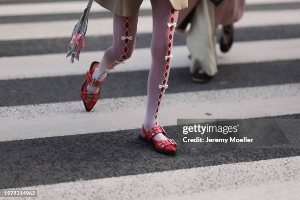 Guest is seen wearing white tights with ribbons, silver handbag and red flat women's shoes white buckle pointed toe slingback ballerinas outside Jean...