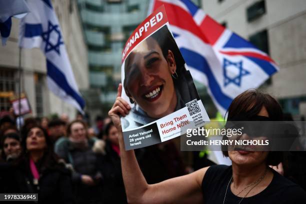 Blindfolded protester wearing fake blood make-up and holding a placard takes part in a demonstration "Rape is NOT resistance" outside the BBC...
